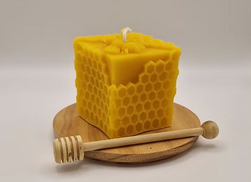Artisan cube candle featuring honeycomb patterns.