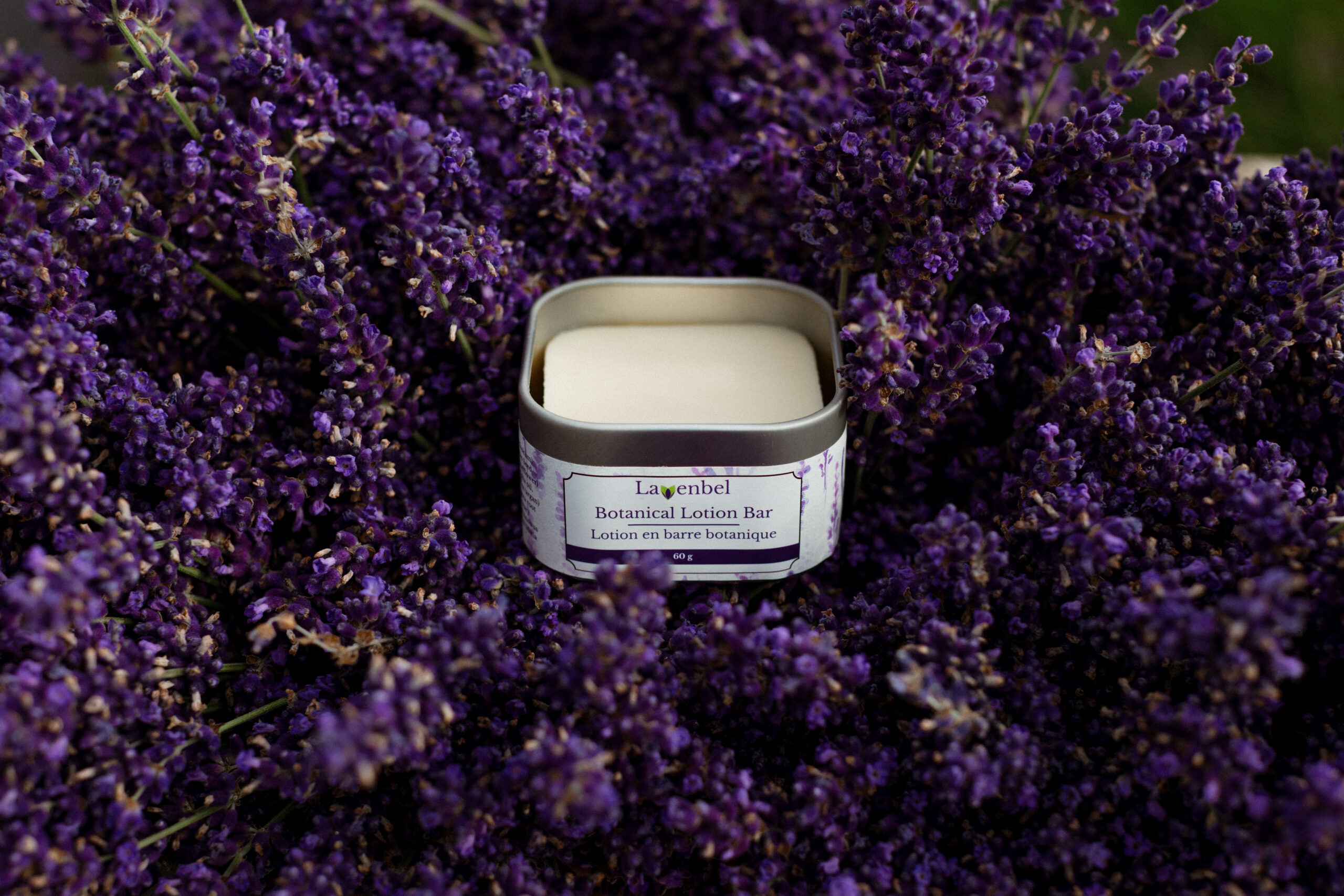 Lavenbel botanical lotion bar in its box, nestled in a lavender bouquet.