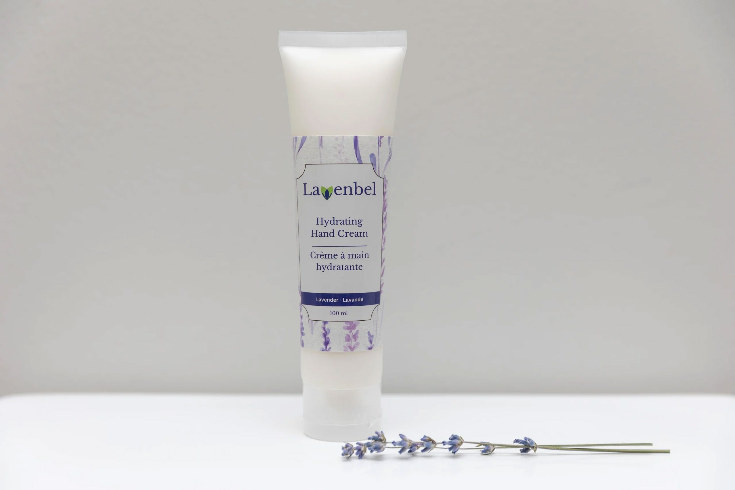 Lavenbel moisturizing hand cream tube with a sprig of lavender.